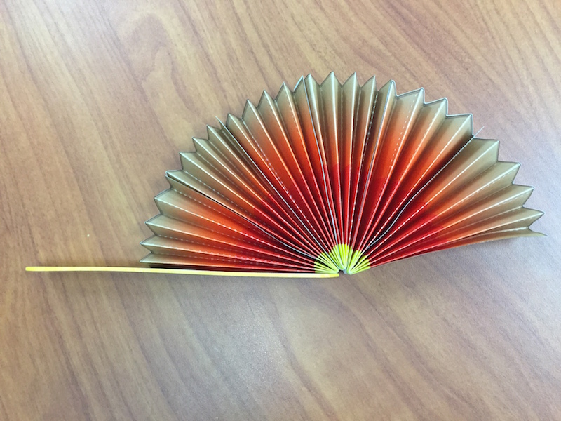 a photo of all three wedges being glued together and attached to one popsicle stick