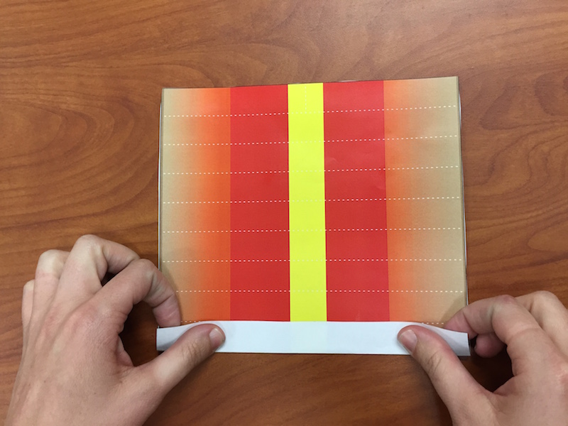 a photo showing hands making the first fold