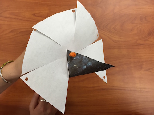 One flap is folded so the hole goes over the pipecleaner.
