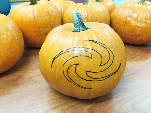 an outline of a galaxy shape on a pumpkin
