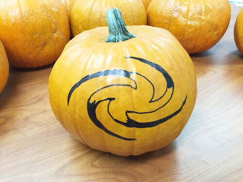 a partially filled in galaxy shape on a pumpkin