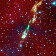 Baby solar system: This could be a baby picture of our own solar system. A young star shoots out jets of gas. The star is hidden in the dusty disk that may one day become a system of planets like our own.