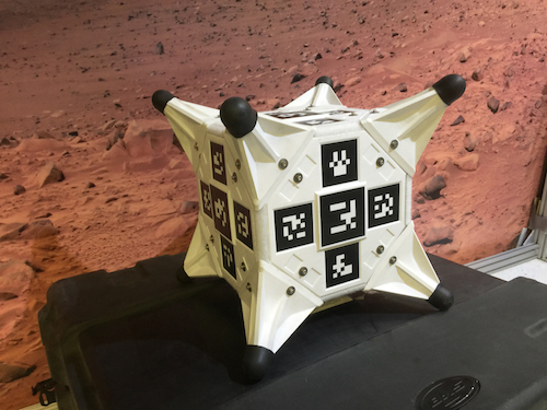 A photograph of the cube-like white and black Hedgehog robot.