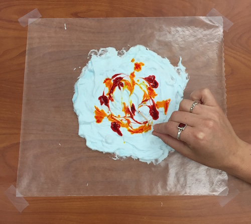 a toothpick is used to spread the food coloring around