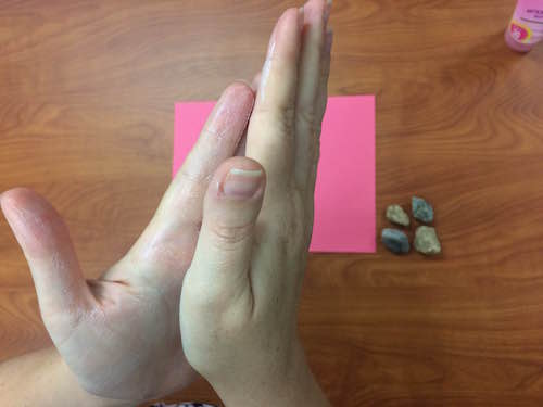 rubbing sunscreen between hands
